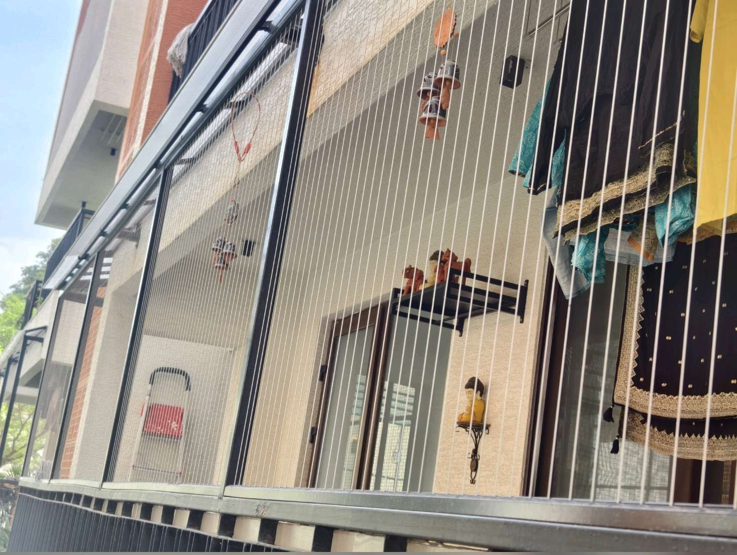 Building facade with installed grill cables — real YPL work shown for Somangalam customers