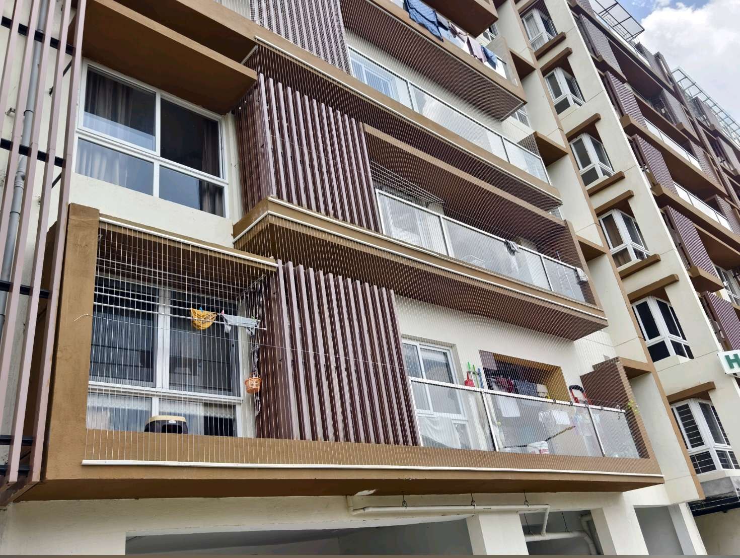 Multi-level apartment exterior with balcony openings — real YPL work shown for Padur customers