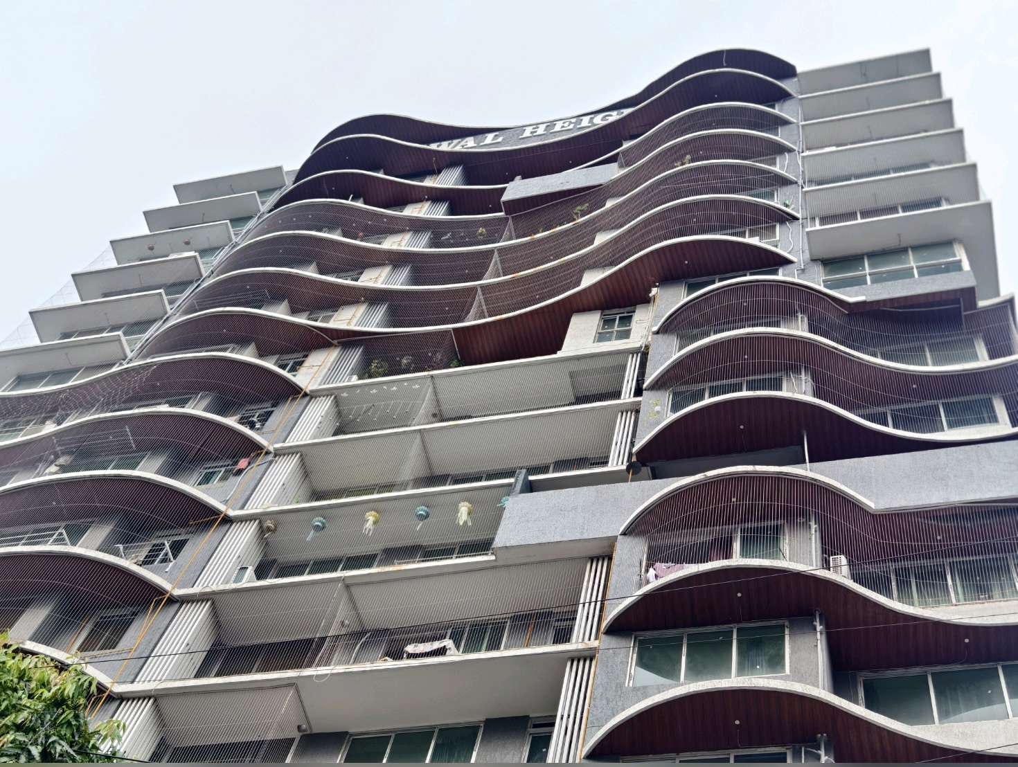 Curved balconies on a residential tower — real YPL work shown for Alapakkam customers