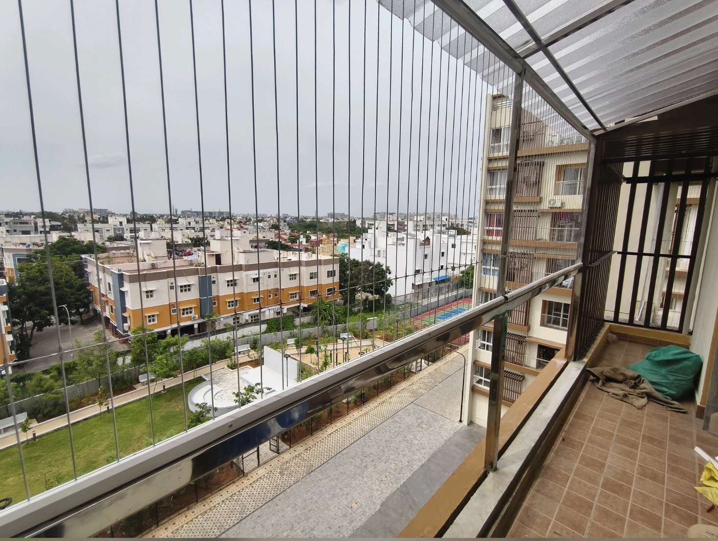 Long balcony with railing and vertical grill cables — real YPL work shown for Uthandi customers