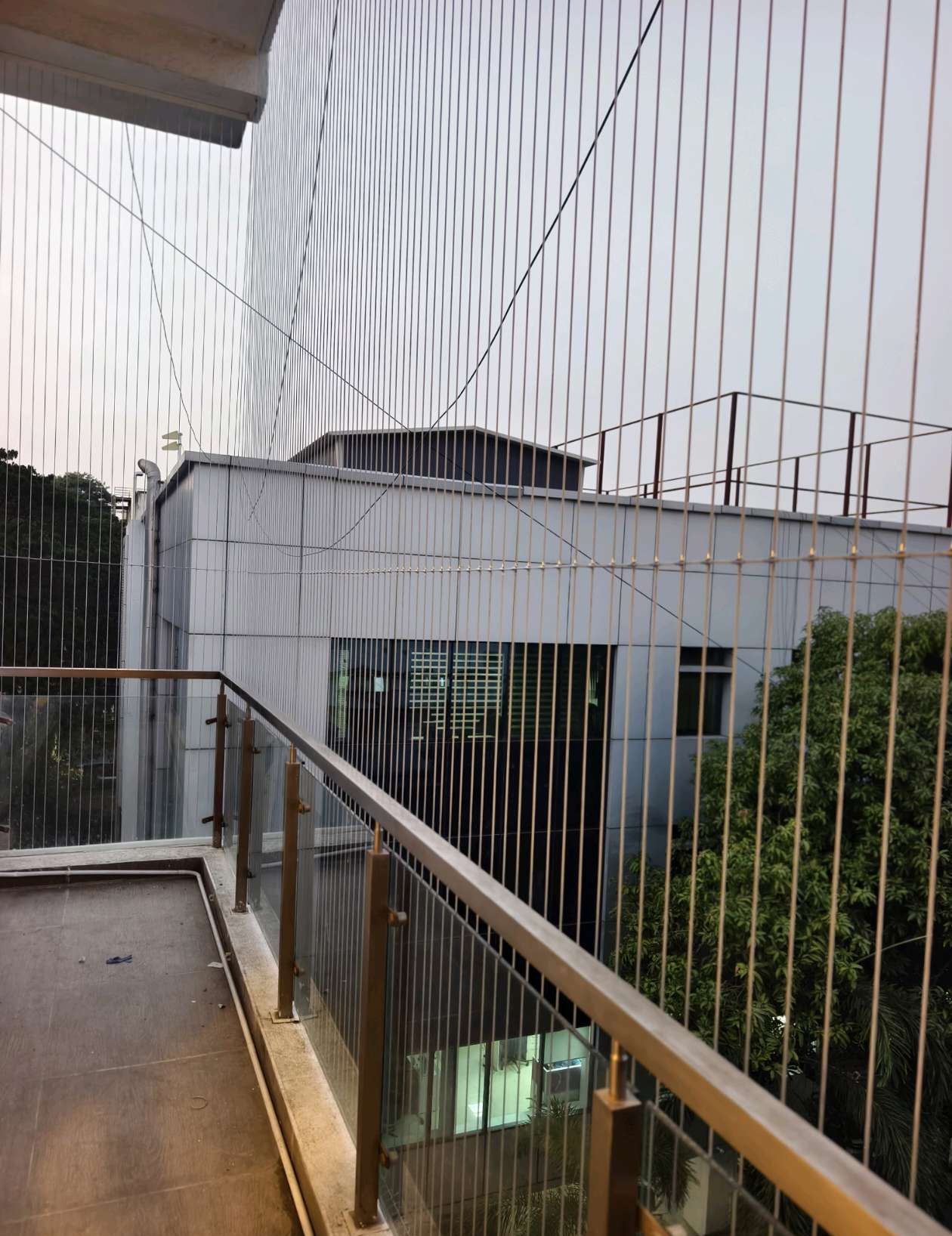 Side view of a balcony fitted with fine cables — real YPL work shown for Kovalam customers