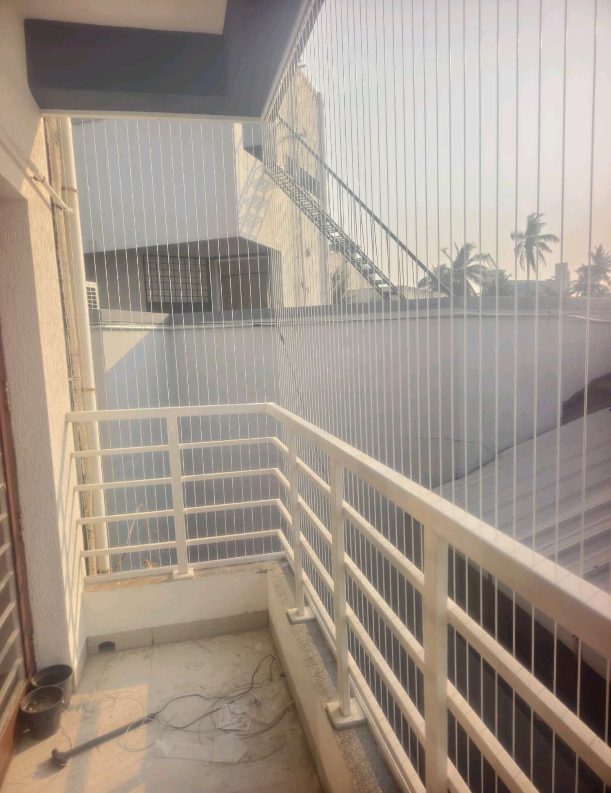 Stair landing with fine vertical protective cables — real YPL work shown for Ullagaram customers