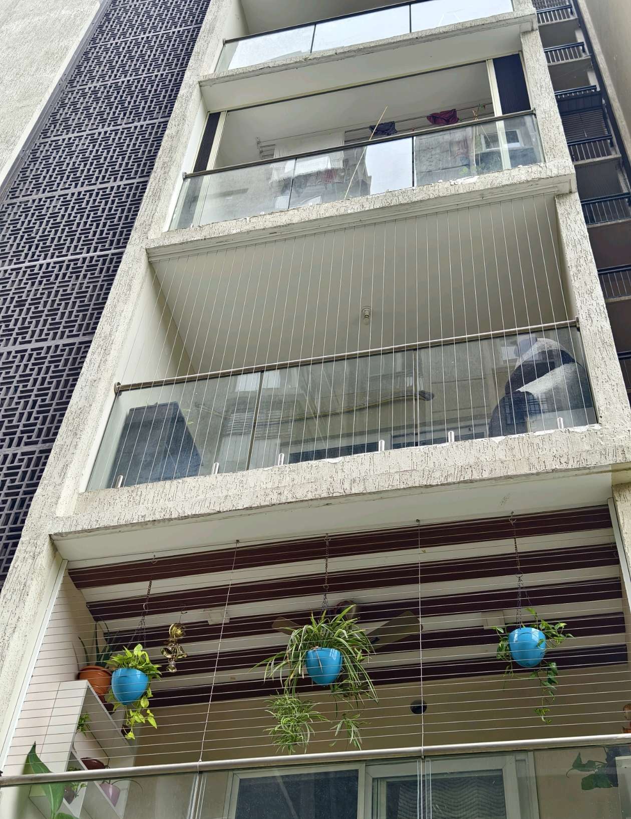 Apartment building facade with balcony grill installations — real YPL work shown for Moulivakkam customers
