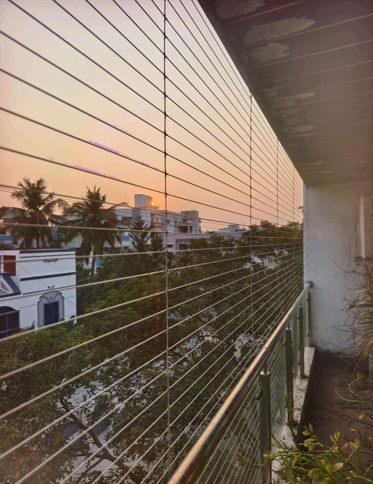 Balcony with horizontal protective cables at sunset — real YPL work shown for Padur customers