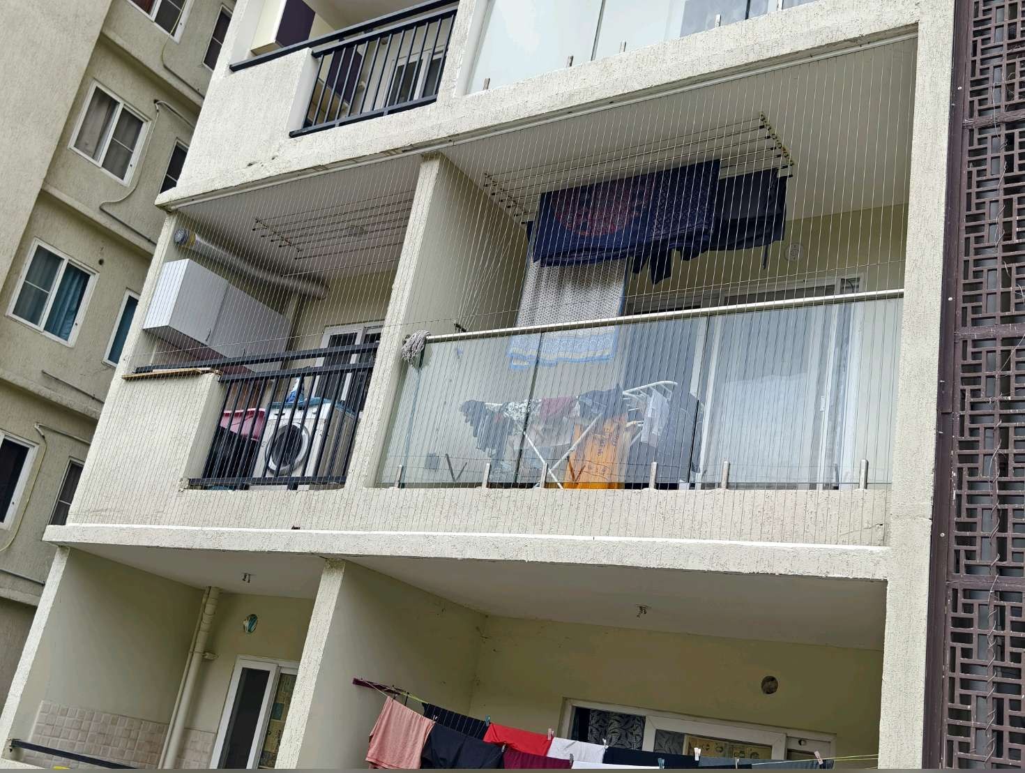 Protected balcony openings on an apartment facade — real YPL work shown for Muttukadu customers