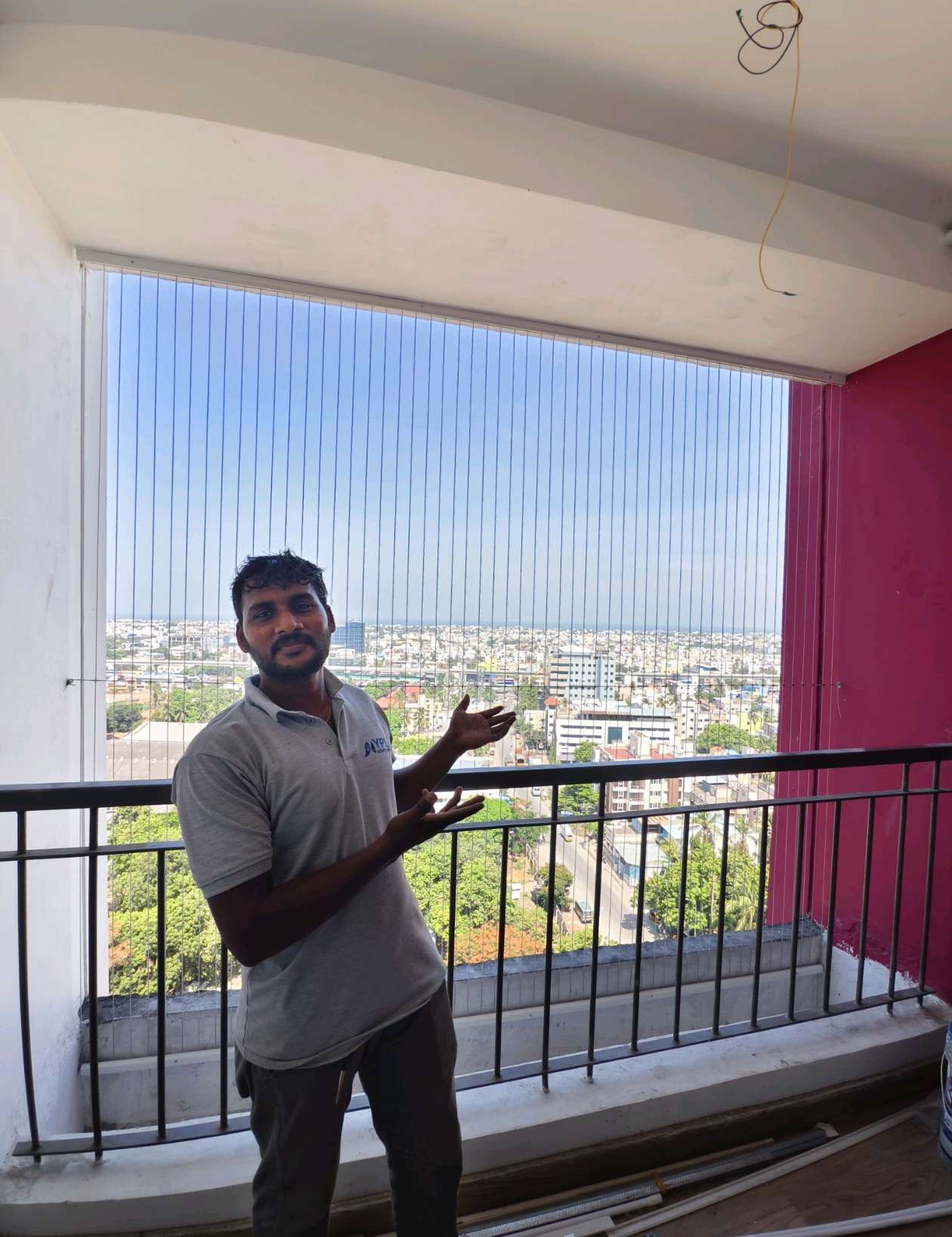 Worker installing cables across a residential balcony — real YPL work shown for Thoraipakkam customers