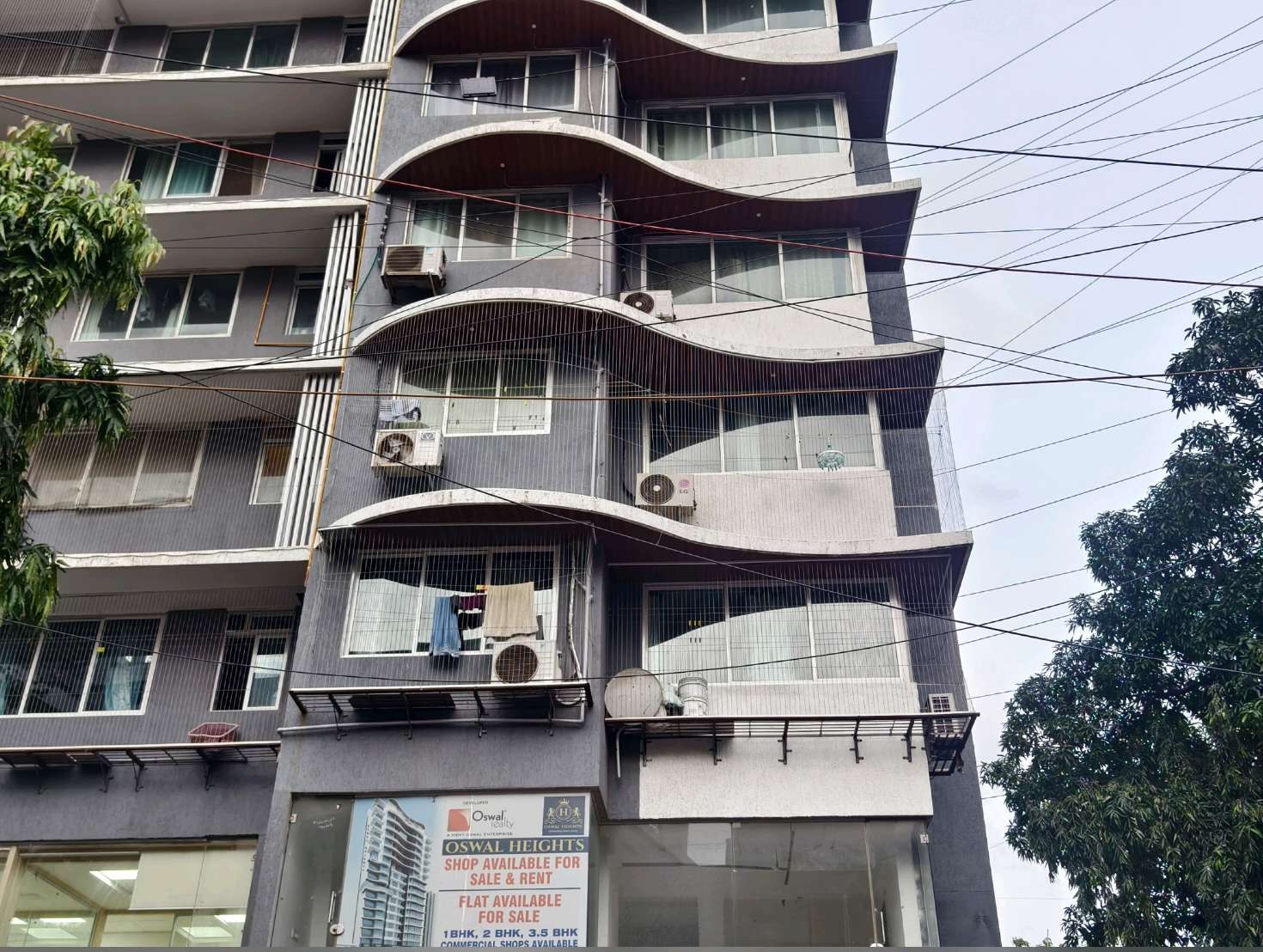 Curved apartment balconies seen from street level — real YPL work shown for Ennore customers
