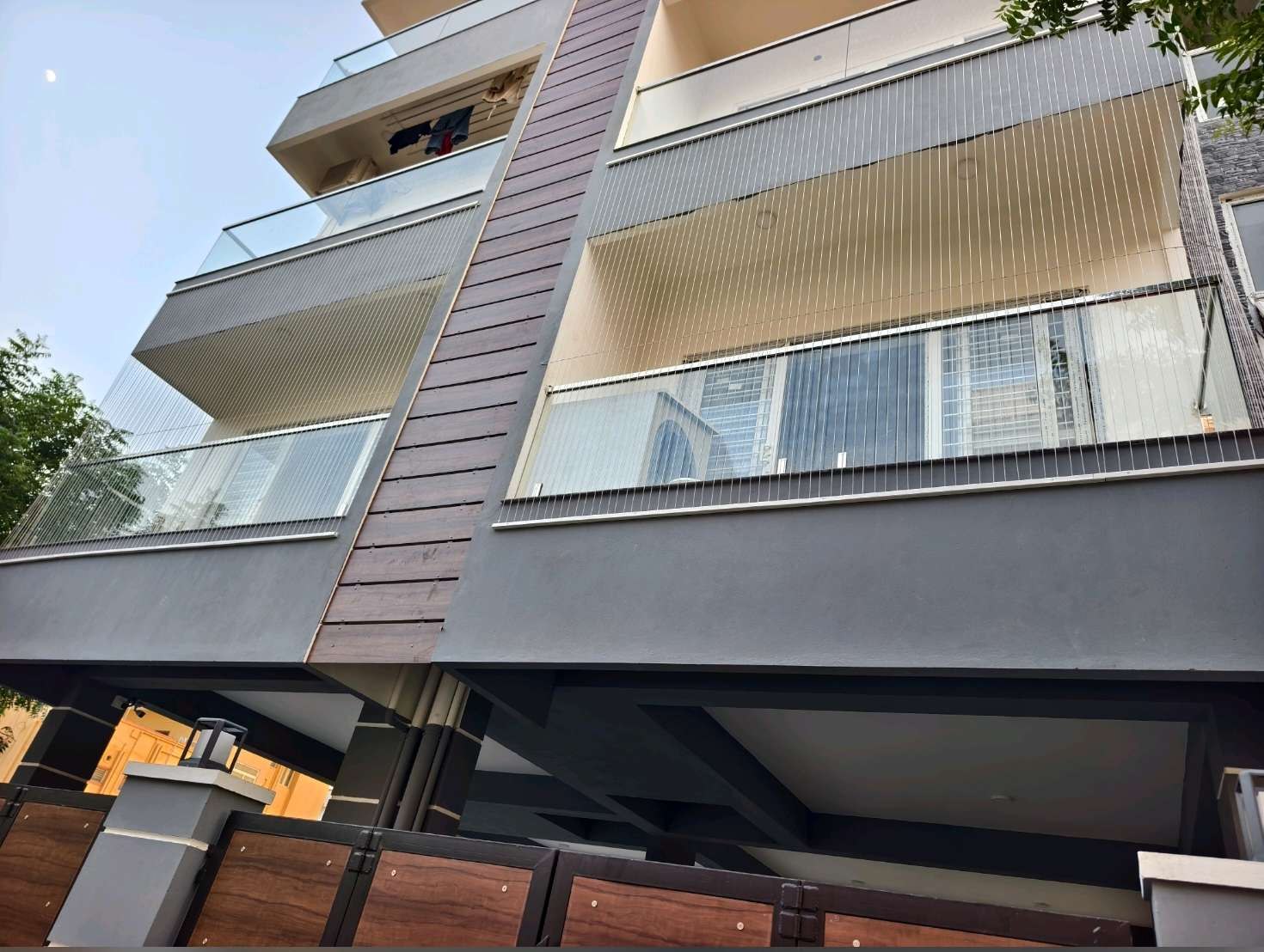 Apartment building exterior beside a protected balcony — real YPL work shown for Athipet customers