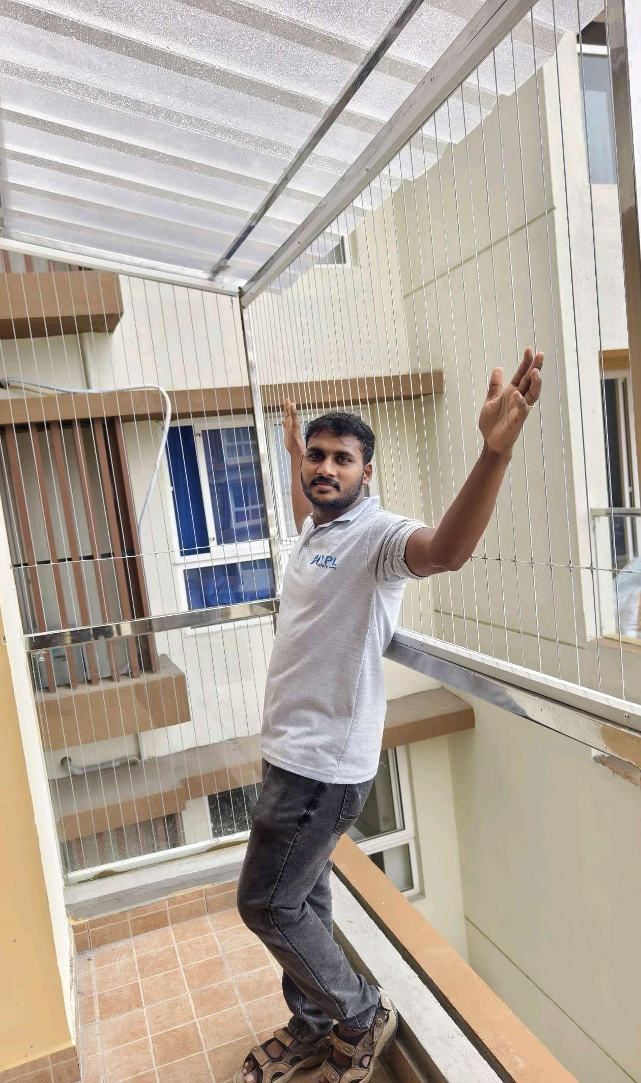 Installer working in a narrow window alcove — real YPL work shown for Cheyyur customers