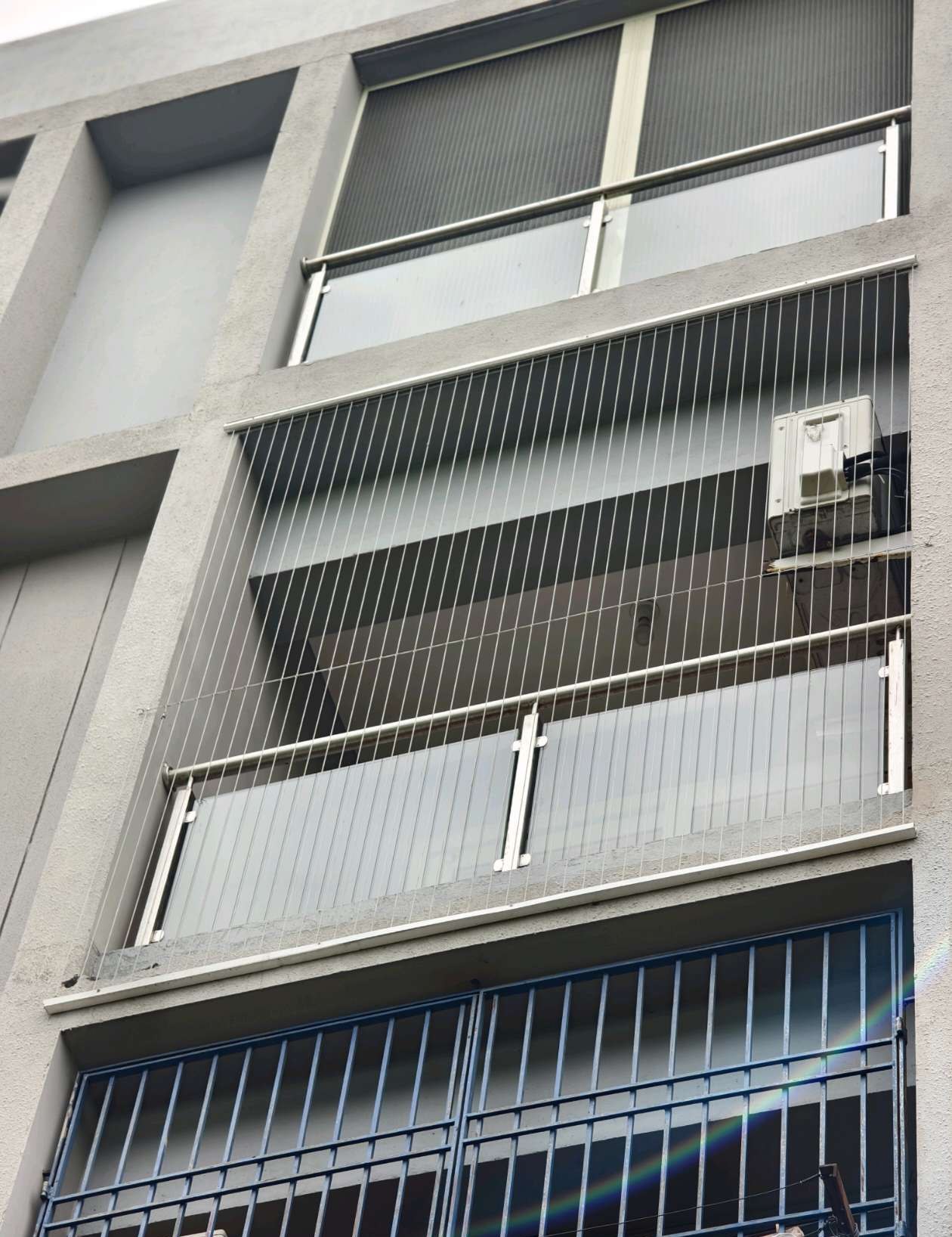 Apartment balconies with grill installations seen from below — real YPL work shown for Perungalathur customers