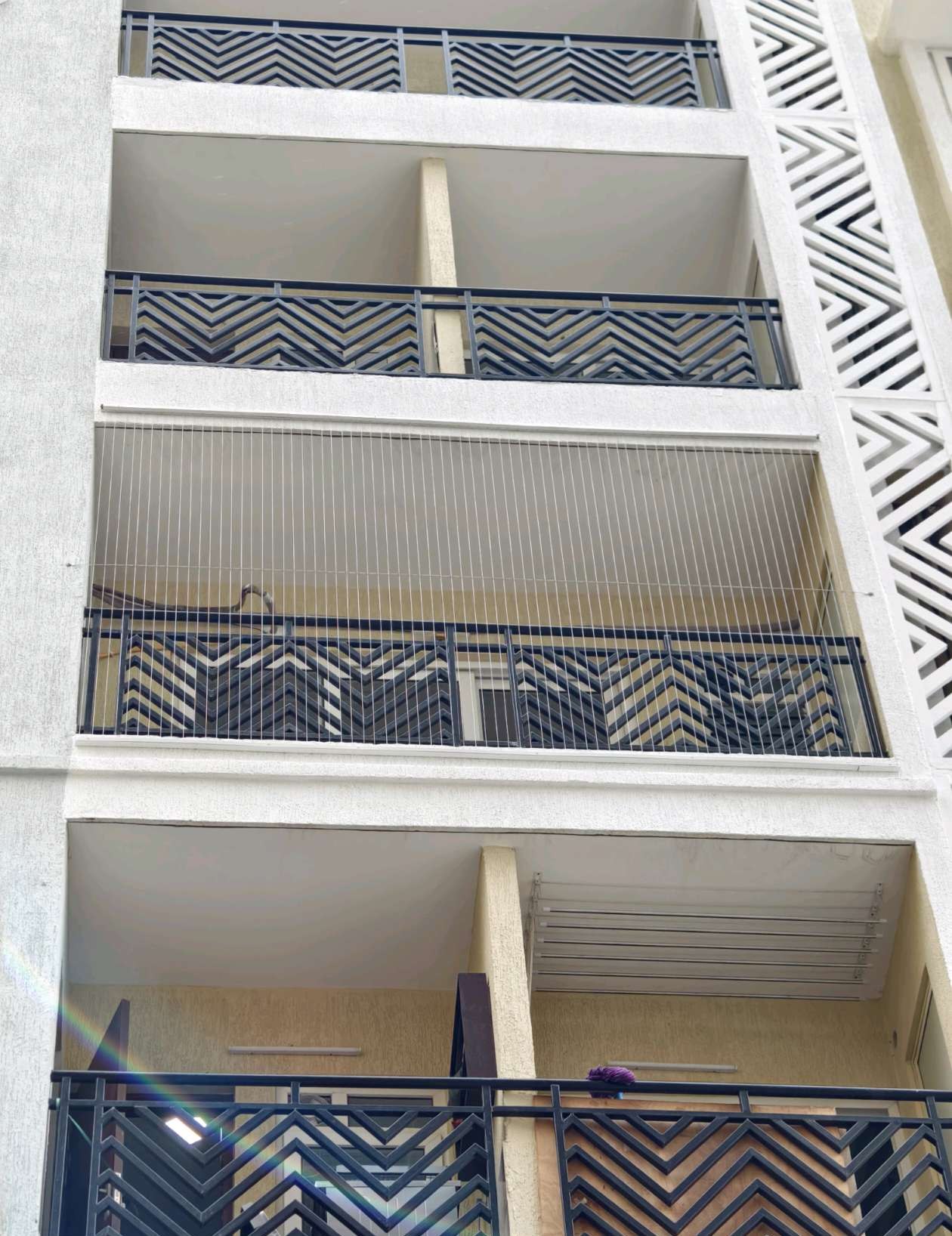 Multi-storey residential balconies with fitted grill cables — real YPL work shown for Kovalam customers