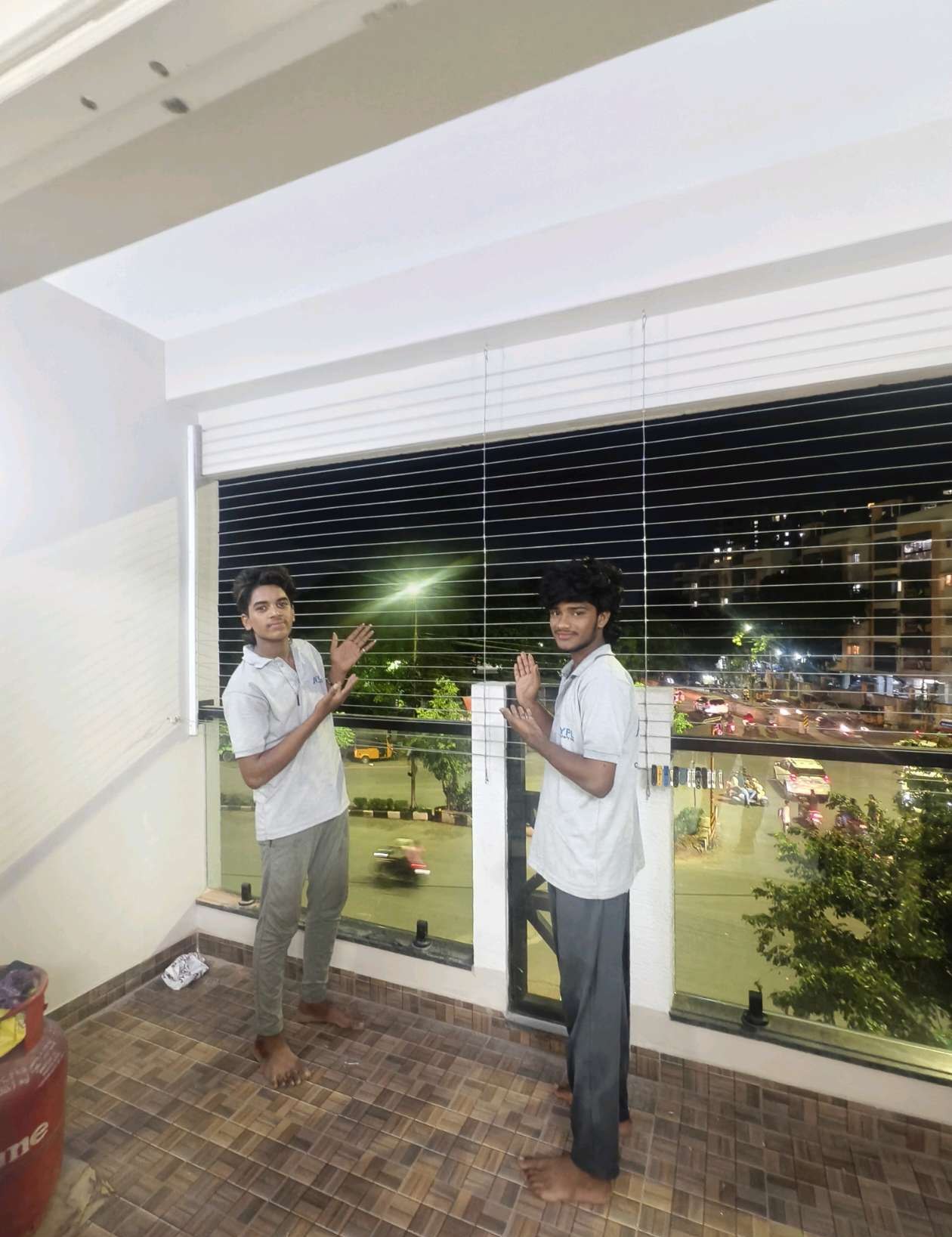 Worker installing grill cables across a wide window — real YPL work shown for Anna Salai customers