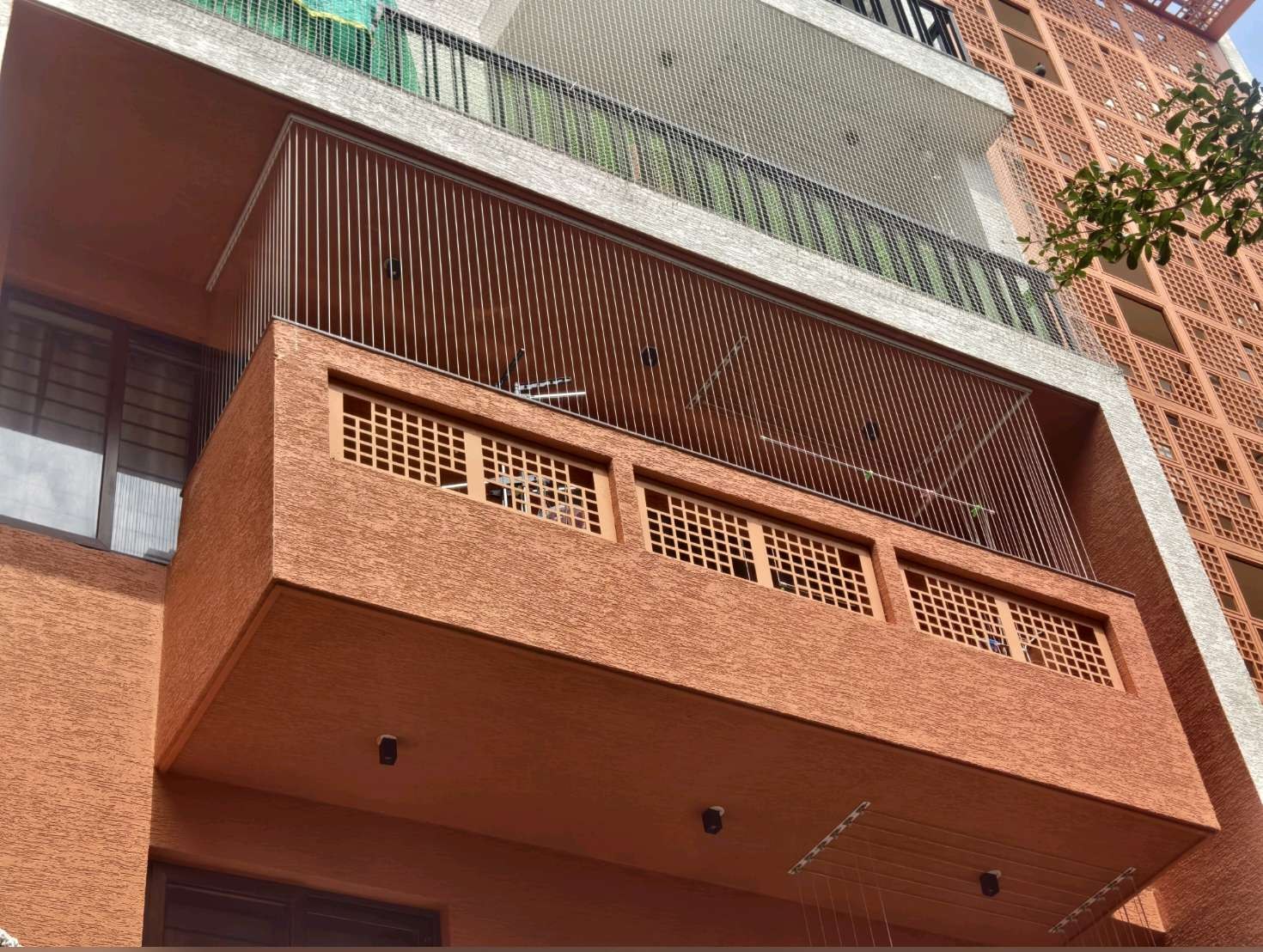 Residential facade with protected balcony openings — real YPL work shown for Ayanavaram customers