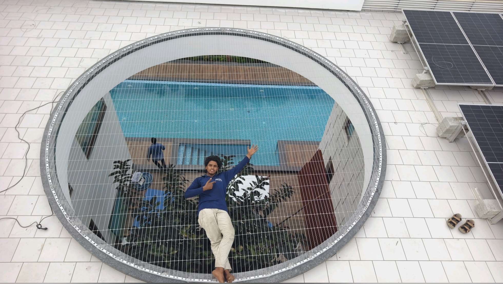 Worker installing invisible grill cables in a circular window