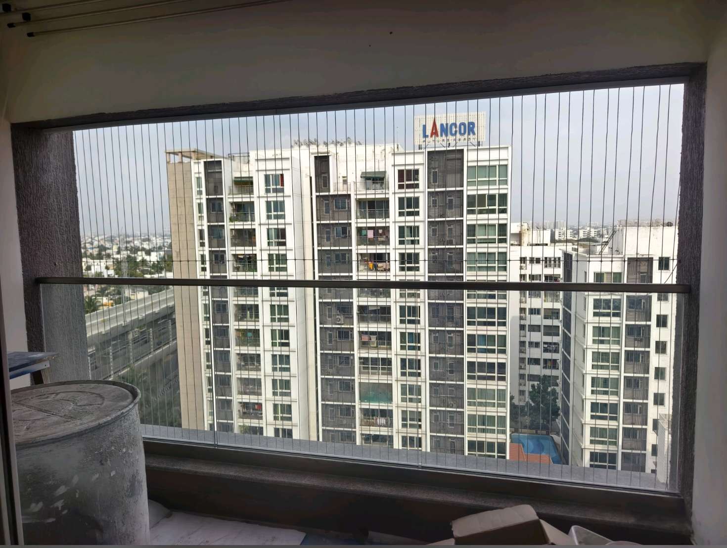 Wide living room balcony protected by fine grill cables — real YPL work shown for Acharapakkam customers
