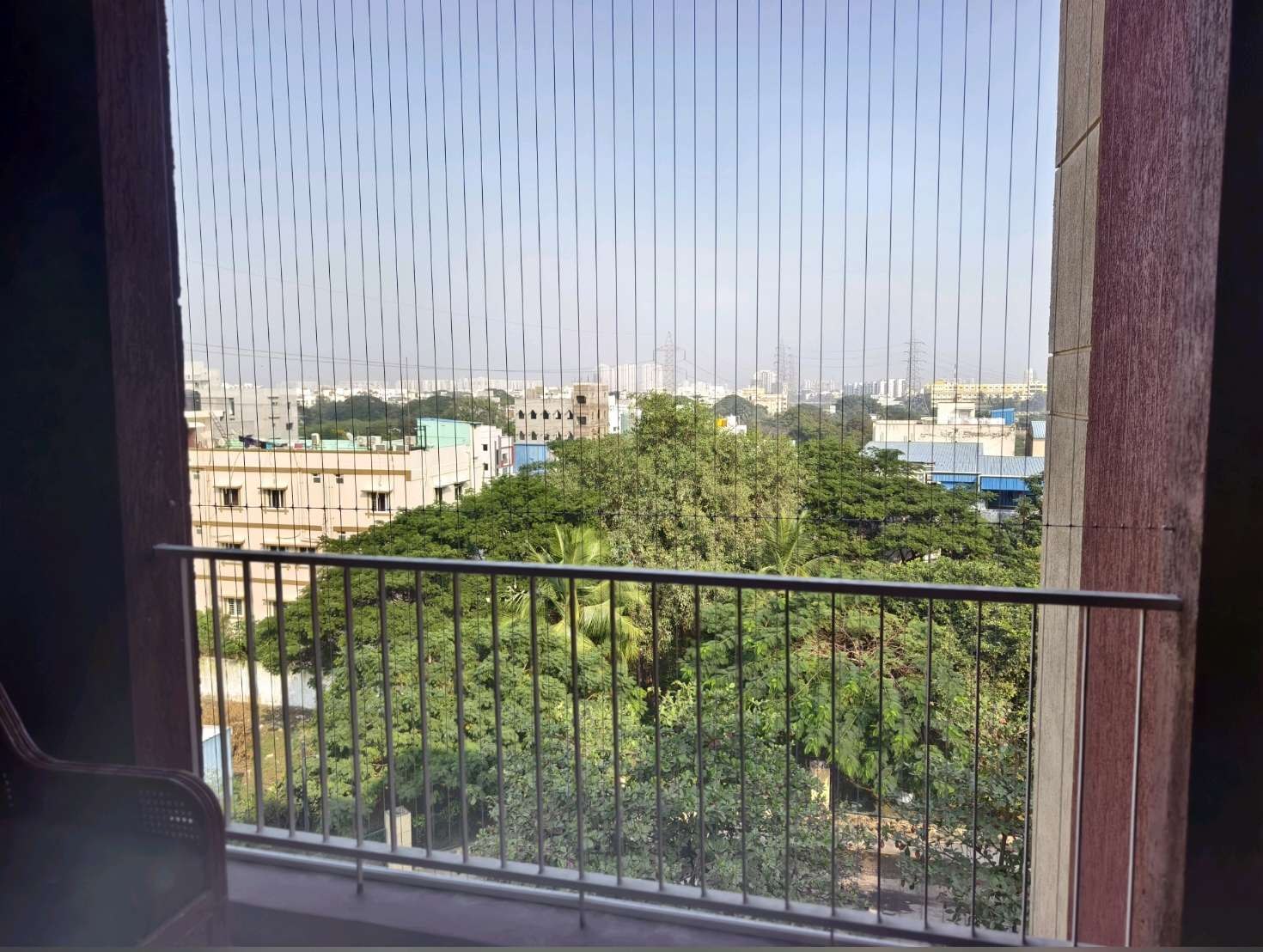 Balcony opening with grill cables overlooking trees — real YPL work shown for Cheyyur customers