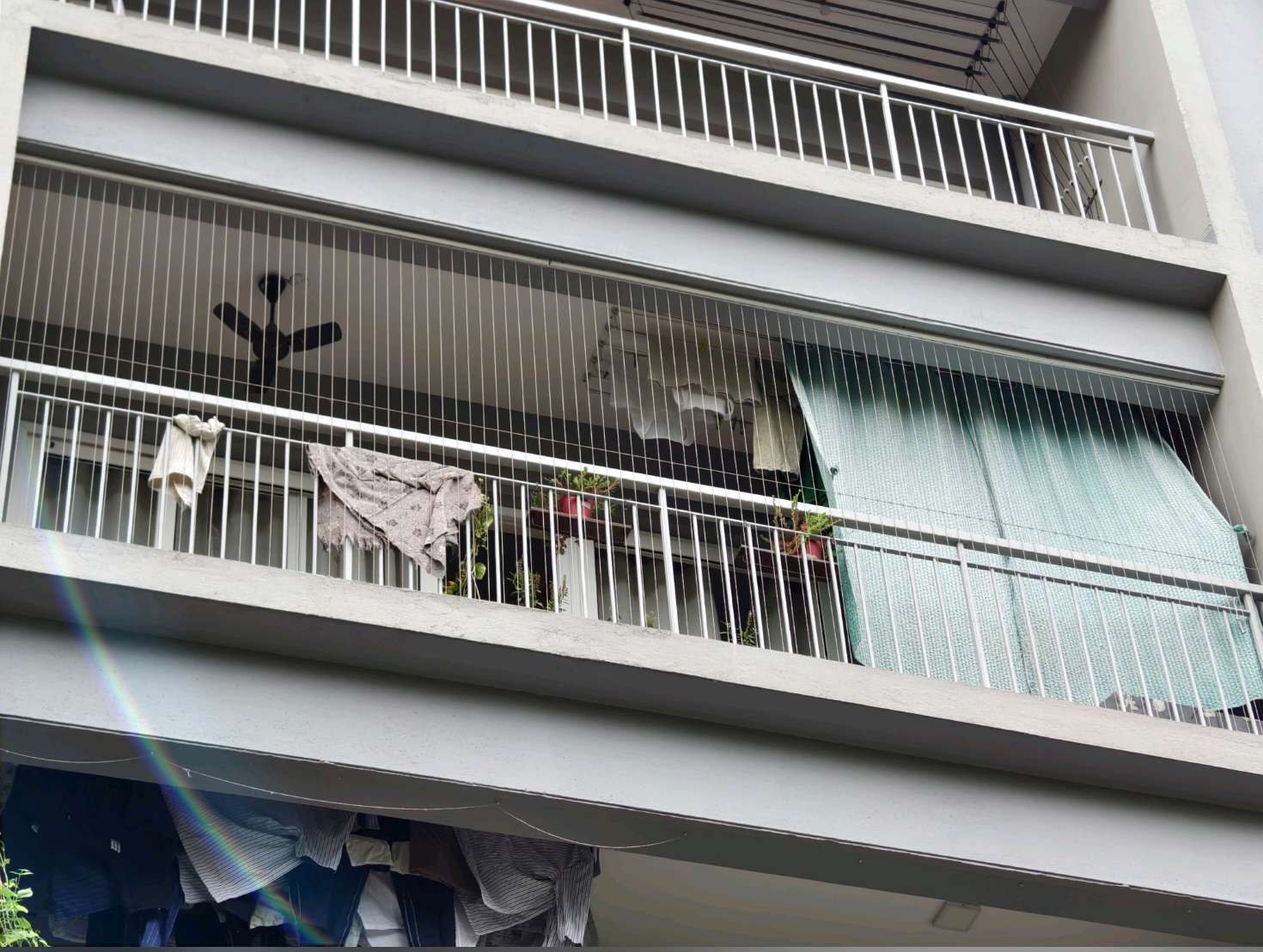 Residential balconies with fine protective cables seen from outside — real YPL work shown for Chintadripet customers