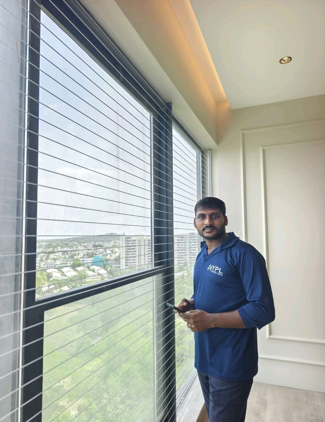 Installer standing inside a protected apartment balcony